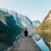 person on a bridge near a lake