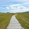 boardwalk clouds country countryside